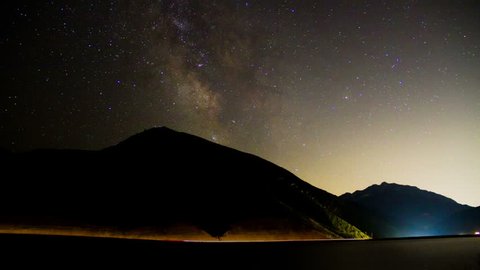 The Milky Way looms over a mountain highway.