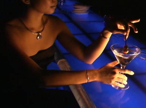 Girl at Bar stirring a martini