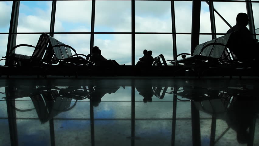 People silhouettes walking at airport space