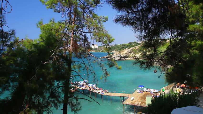 A view of a rocky beach with bridge from a high angle