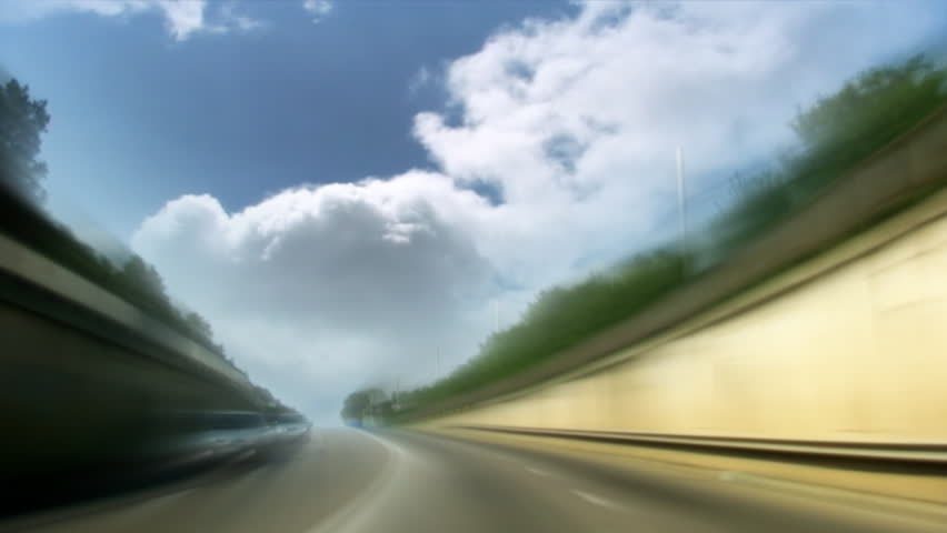 Road with time lapse clouds speed tunnel