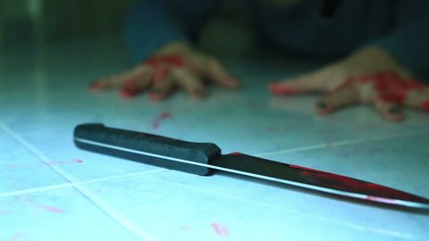 Female murder victim trying to reach a blade