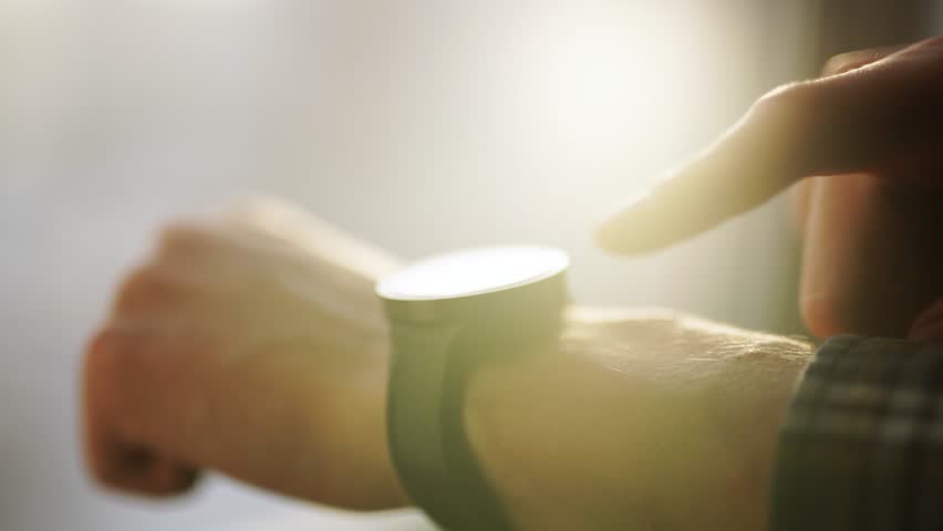 In hall station a man using his smart watch app. Close-up hands
