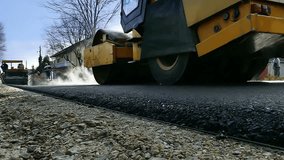 Road roller on hot asphalt ; Road roller carried repair works on city streets,slow motion video clip