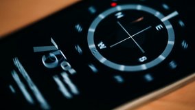 Compass on the phone revolves around its axis. Close up video.