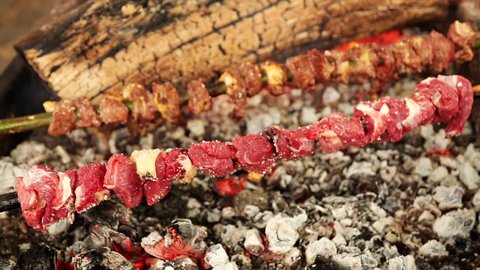 video footage of a meat skewer barbeque with fire. So called Espetada on Madeira island