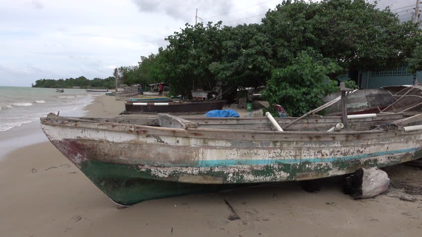 FALMOUTH, JAMAICA - NOV 2015: Jamaica sandy beach coastal village fishing boats. Spanish rule after Christopher Columbus in 1494. Independence from United Kingdom 1962. Tourism and mining economy.