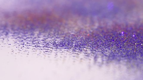 Sparkly Colorful Glitter Falling In Slow Motion On To White Background