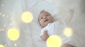a newborn baby is around glowing lights, Dolly shot