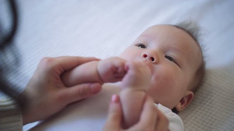 Close Up Parent holding Newborn baby