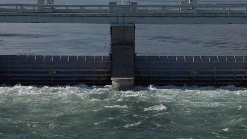 Dam with flowing water at hydroelectric power station on the river