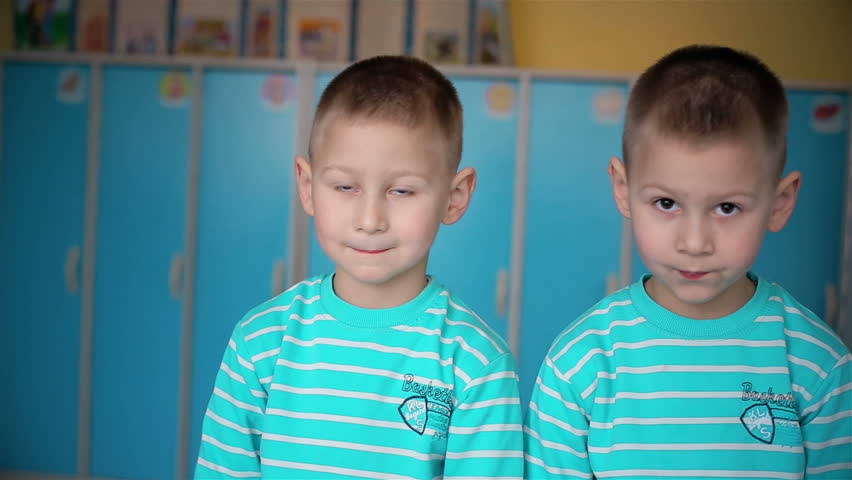 Looking twins boys in camera