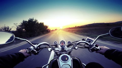 A motorcycle road adventure going forward to the sun in high speed. pov at sunset. VINTAGE