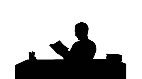 Silhouette Portrait of a male student reading a book