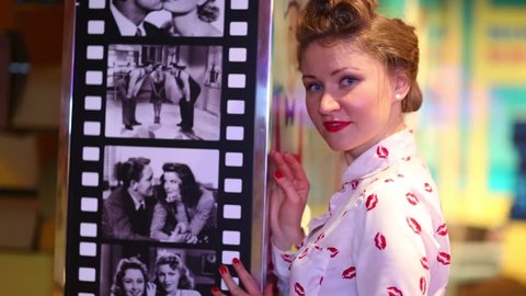 MOSCOW - JAN 18, 2015: Woman near film on wall (model with release) during Retro Beauty Day in Beverly Hills Diner