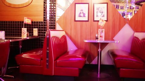 MOSCOW - JAN 18, 2015: Red sofas and portraits of american stars in Beverly Hills Diner - network of stylized American restaurants in Moscow