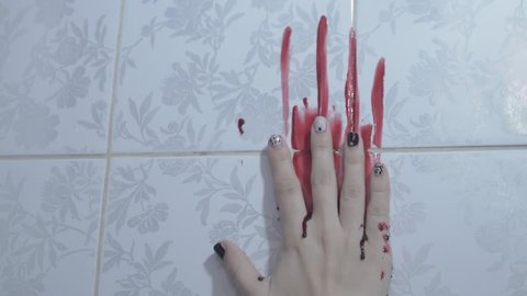 bloody girl's hand on the wall