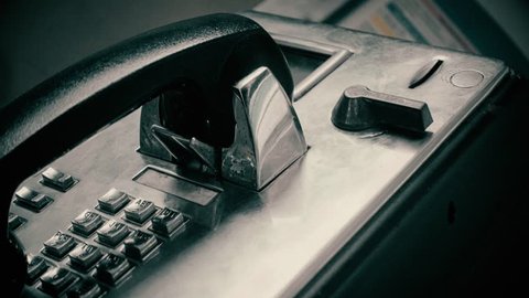 Making a quick phone call on a public phone, bottom perspective. 4k