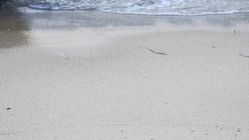 Sea waves splashing on beautiful white sand with copyspace