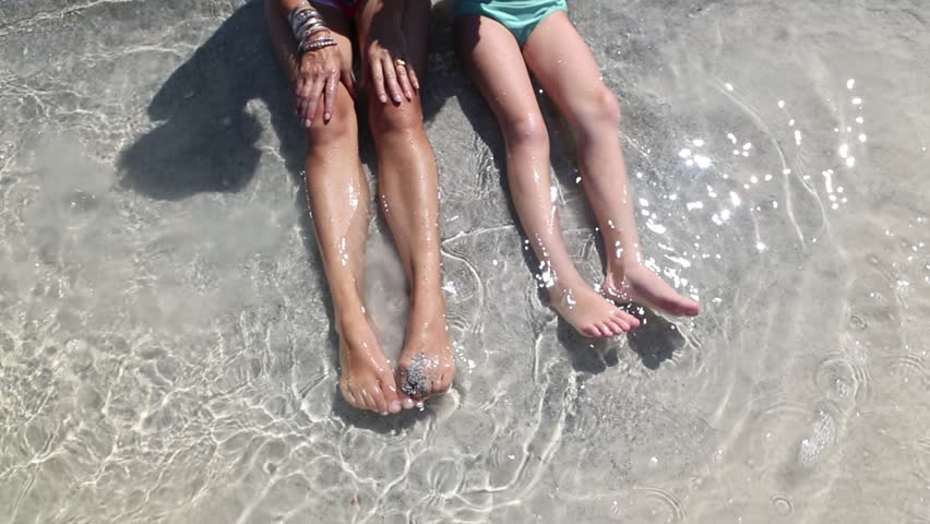 Ocean feet. Children Splash Water with their feet.