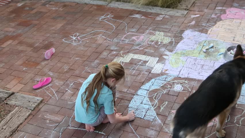 9 year old girl coloring the floor with chalk