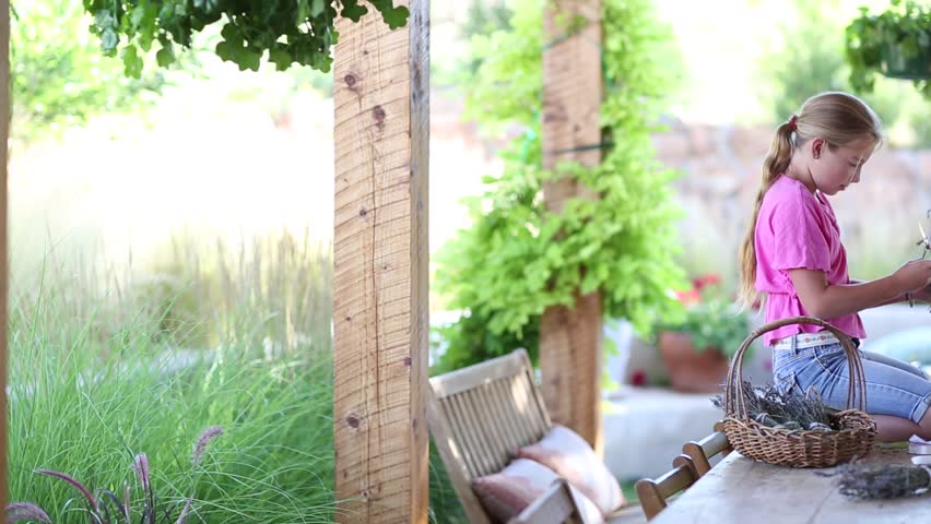 mother and daughter wrapping lavender in bundles