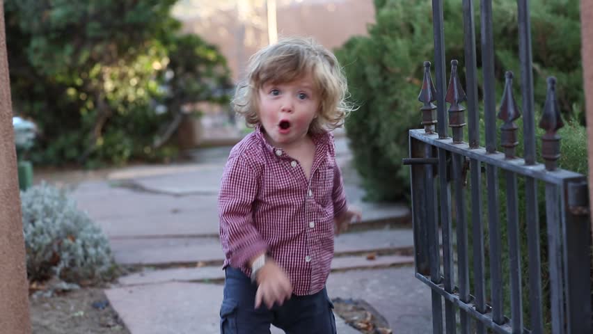 9 year old girl and toddle boy playing at the gate