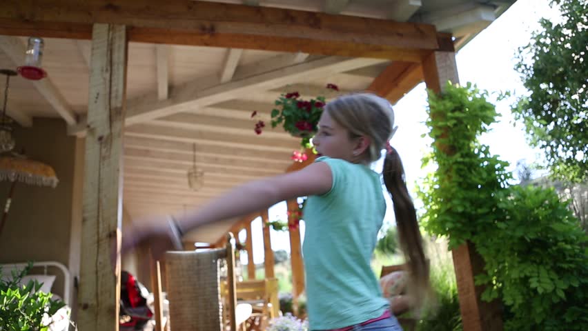 Preteen girl playing catch with football