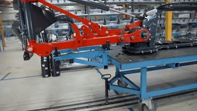In this video, we can see a huge machine that is moving on a trolley in the factory. Close-up shot.