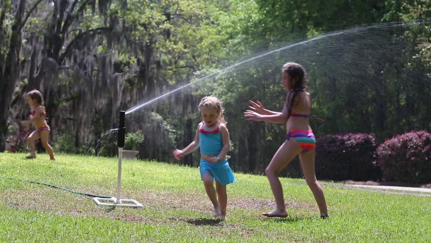 kids playing in sprinkler