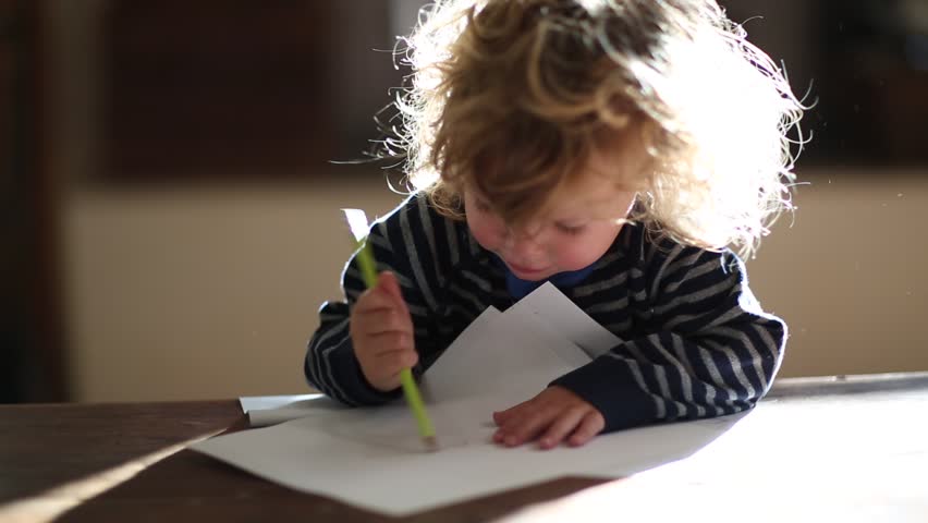 Toddler boy drawing with marker