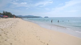 Unrecognizable people on Phuket beach, Thailand. Slow motion video