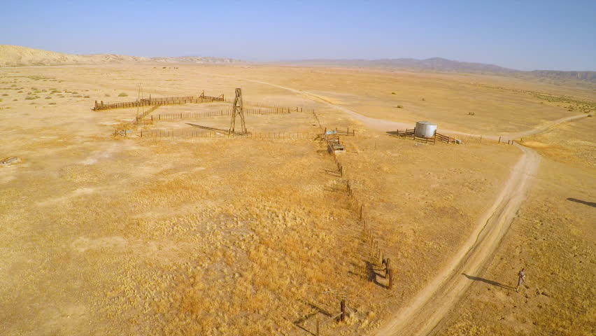 CARRIZO PLAIN - CIRCA 2015 - An aerial over a man walking to his car near an abandoned ranch in the desert of the Carrizo Plain.