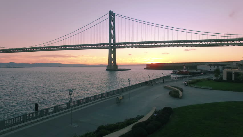4K Aerial drone shot San Francisco toward bay bridge sunrise traffic above