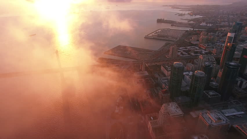 4K Aerial drone shot San Francisco downtown bay bridge sunrise above clouds