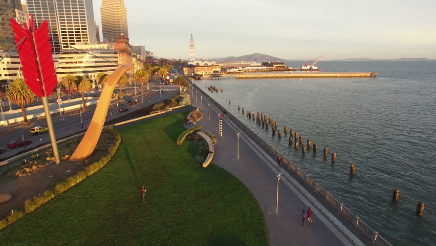 4K Aerial drone shot San Francisco embarcadero park above view follow people
