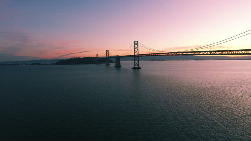 4K Aerial drone shot San Francisco forward along bay bridge sunrise