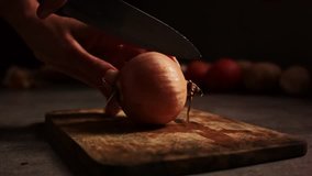 Crude onion being cut on two pieces.
