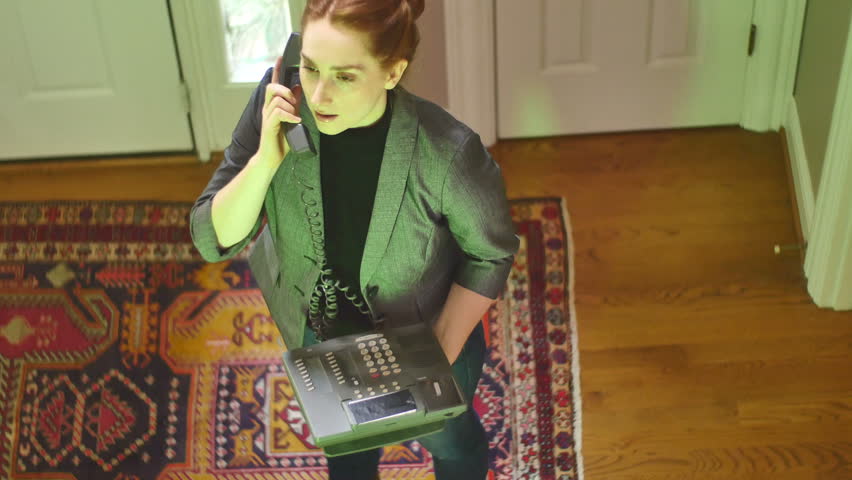 A businesswoman or Realtor on the phone