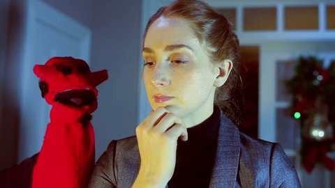 Conscience concept, devil puppet talking to woman