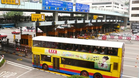 HONG KONG - FEBRUARY 22, 2015: Toll road gate and cashier, automated and cash payment, vehicle traffic. Many taxi cars drive through, and few buses on auto-payment lane. Cashier booth in line across