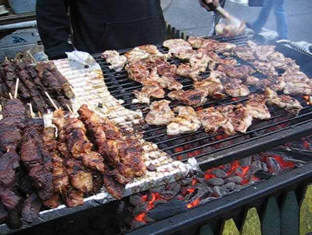 man barbecuing at street fair