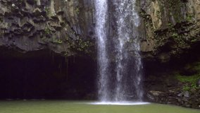 Tropical Waterfall in Lush Green Hawaiian Jungle. Adventure Leisure Vacation Slow Motion