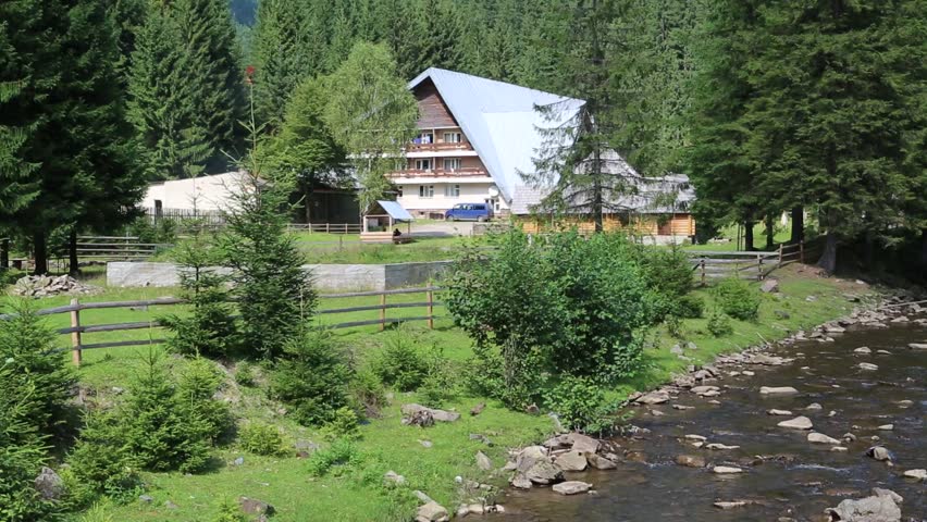 Cottage near mountain river in Carpathians, Ukraine