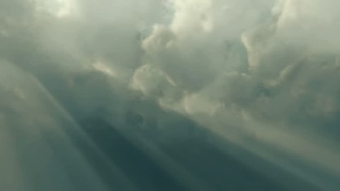 Clouds 1525: Sunbeams shoot through time lapse clouds (Loop).