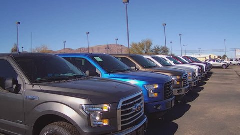 KINGMAN, AZ/USA - December 29, 2015: A row of new pickup trucks at a car dealership. New trucks ready for sale are on display at the car lot.