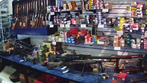 KINGMAN, AZ/USA - December 29, 2015: Shot of rifles and ammunition on display at a pawn shop. A pawn shop has a wide selection of weapons on sale.