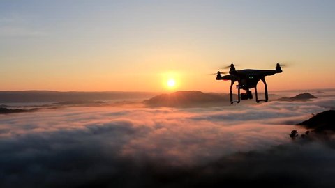 drone flying over cloud in morning, in a aerial shot, 