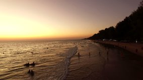 people vacation on sea beach with beautiful sun set sky behind