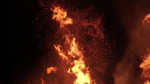 Close-up of flames, sparks and smoke in slow motion.